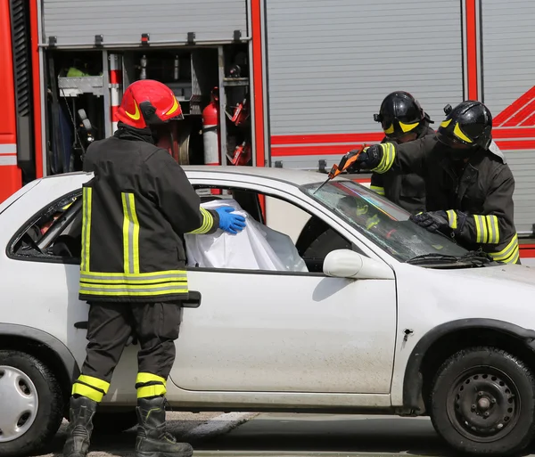 Firefighters in action after the road accident — Stock Photo, Image