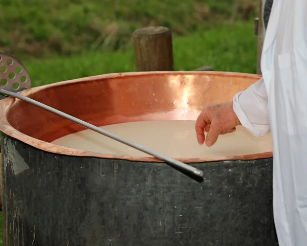 Cheesemaker checks with hand the milk's temperature inside the c — Stock Photo, Image