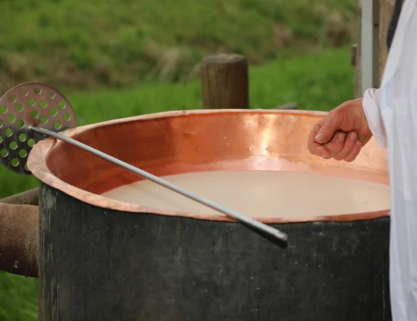 Formaggio controlla con mano la temperatura del latte all'interno del b — Foto Stock