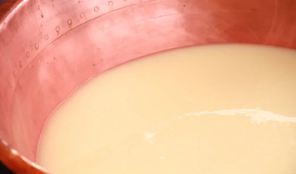 Copper pot with the milk and the whey for the production of chee — Stock Photo, Image