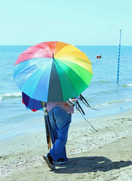 Vendedor ambulante de sombrillas en la playa — Foto de Stock