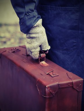poor person with the old worn leather suitcase in search of work clipart