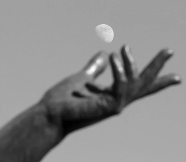 Mano di statua cercando di catturare la luna nel cielo — Foto Stock