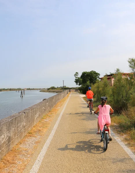 Two little boys are riding near the lagoon of Venice in summer — Stock Photo, Image