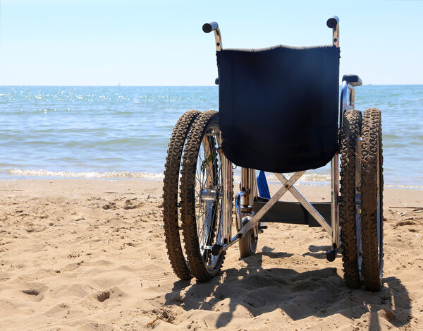 wheelchair on the sand of the beach