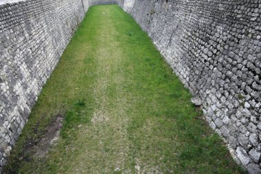 large large moat with huge walls  for the protection of the city during the medieval period clipart