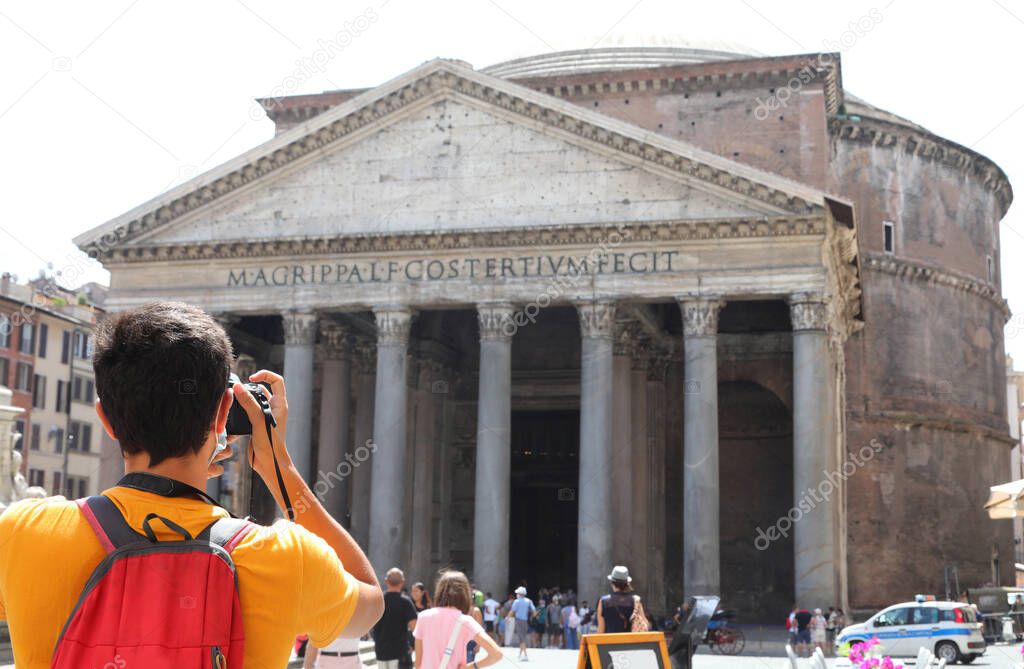 young tourist while taking a photograph at the ancient temple called Pantheon in the Italian capital Rome