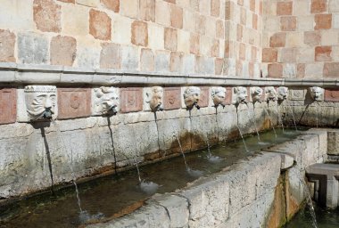 fountain in the Italian city L AQUILA called 99 cannelle which means ninety-nine small straws clipart