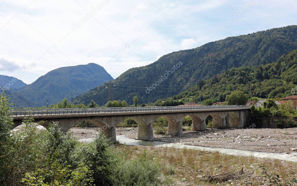 the long bridge over the river in Northern Italy to reach the country on the other side