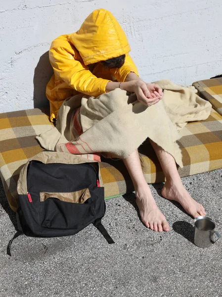 Homeless Young Man Poor Yellow Hood While Asking Alms Passers — Stock Photo, Image