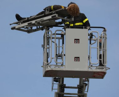 basket of the aerial platform during the rescue maneuver of an injured person with a mobile stretcher