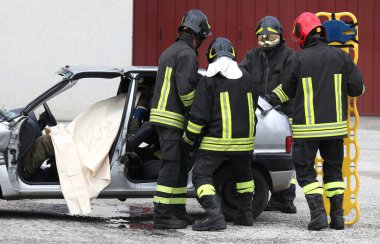 Teams of Firefighters during the rescue of the injured and the stretcher to transport him to the hospital