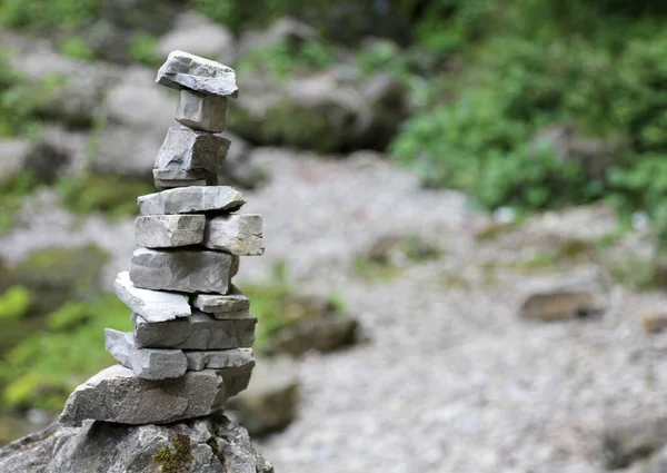 High stack of rocks in the mountains called by CAIRN climbers or small man symbol of prayer or to indicate a path