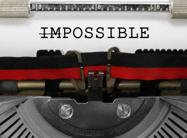 Word Impossible with letters IM deleted writen with an old vintage typewriter