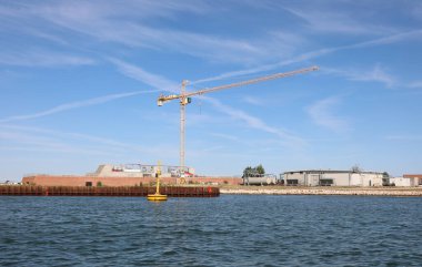 construction site of a wide dam called the Mose project to defend Venice from floods and high tides in Italy clipart