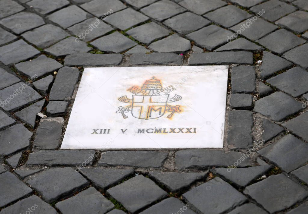 Plaque made by Pope Benedict XVI on the site of the attack which bears the coat of arms of John Paul II and the date May 13 1981 in Roman numerals