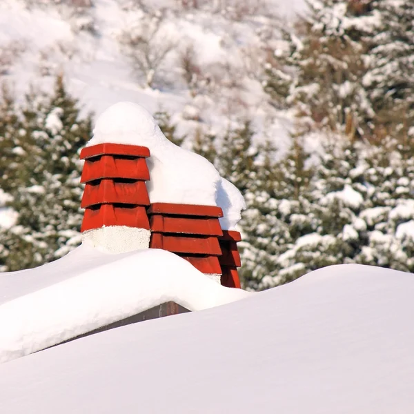 Chimneys of houses covered with snow — Stock Photo, Image