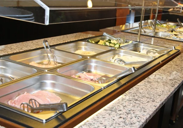 Подносы с едой в столовой ресторана самообслуживания — стоковое фото