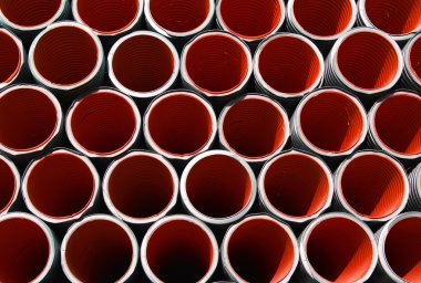 red corrugated pipes for laying electric cables and optical fibe clipart