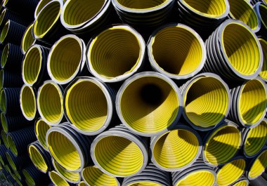 yellow corrugated pipes in a roadworks for laying optical fiber  clipart