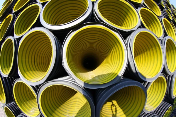 Many yellow corrugated tube photographed with fisheye lens — Stock Photo, Image