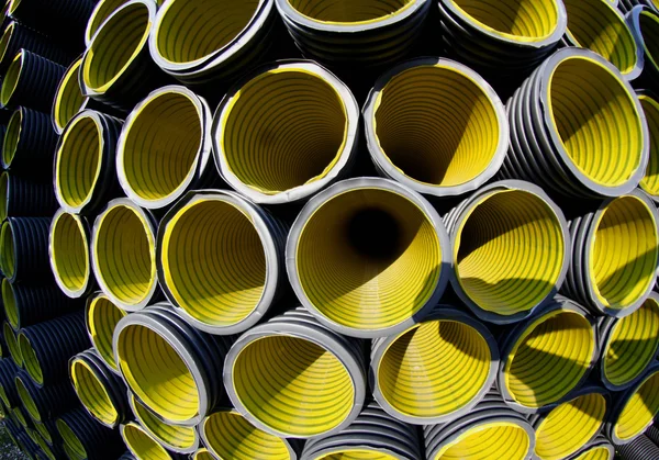 Yellow corrugated pipes in a roadworks for laying optical fiber — Stock Photo, Image