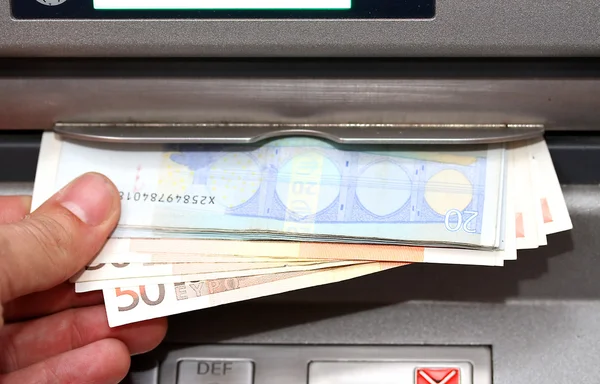 Man takes money in EURO banknotes from an ATM — Stock Photo, Image