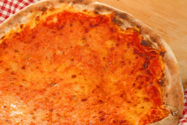 Pizza with mozzarella and tomato served on a wooden cutting boar — Stock Photo, Image