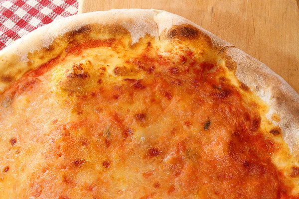 Pizza with mozzarella and tomato served on a wooden cutting boar — Stock Photo, Image