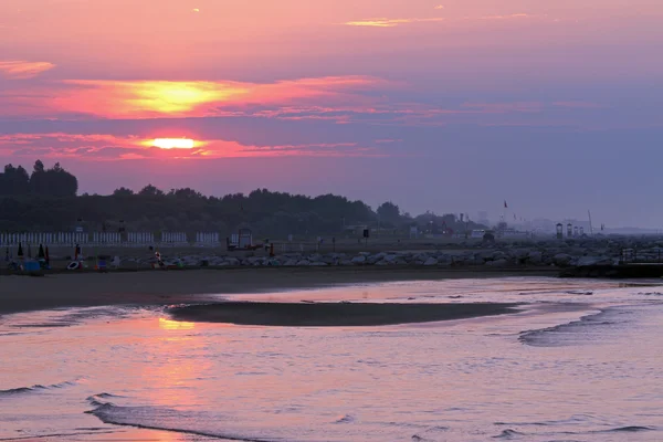 Gondolatok az oc és nagy színes nap a tengerparton a napkelte — Stock Fotó