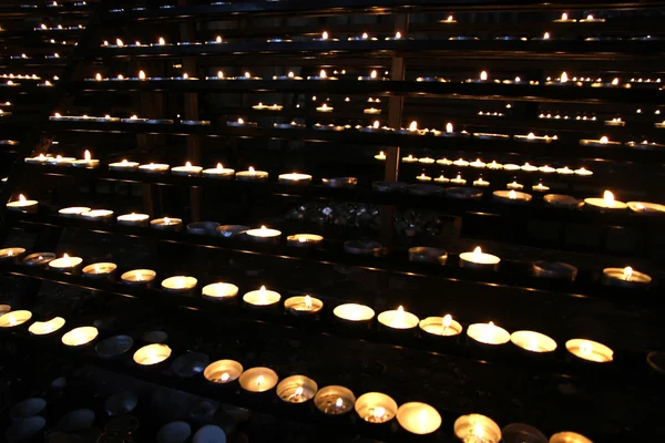 Bougies de cire allumées dans l'église pendant la messe — Photo