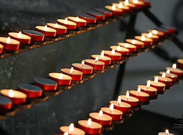 Flames of wax candles during the Eucharistic Celebration in the — Stock Photo, Image