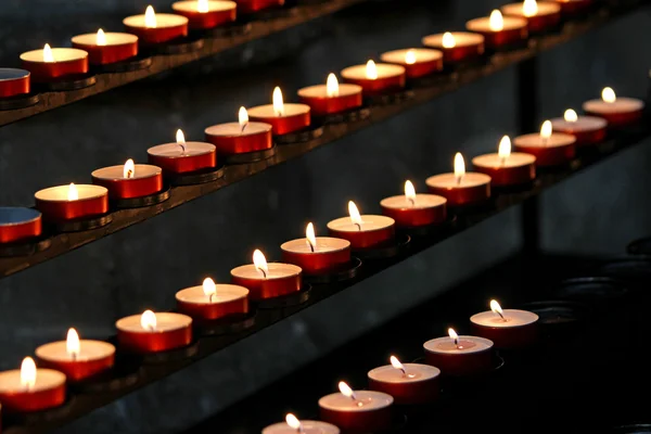 Many wax candles lit in the Church during mass Royalty Free Stock Images