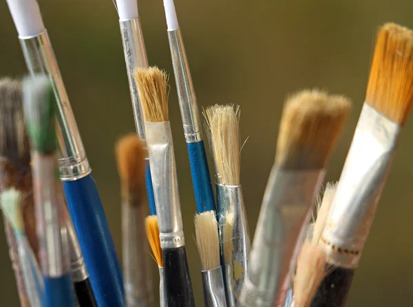 Brushes used by a painter in painting workshop — Stock Photo, Image