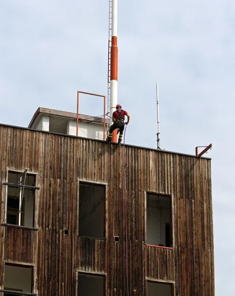 fireman climbing expert during the ascent abseiling from a build