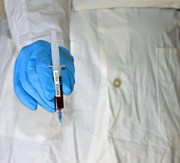 Doctor with glove and the syringe of blood of ebola test — Stock Photo, Image