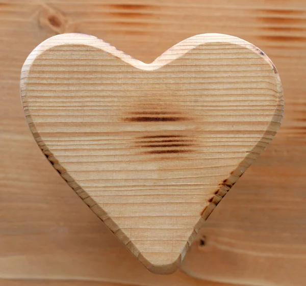 Heart symbol inlaid in natural wood — Stock Photo, Image