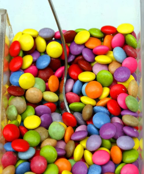 Candy and chocolate colored confetti coconut peanuts — Stock Photo, Image