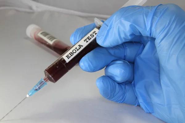 Syringe with blood to make the ebola virus tests during the epid — Stock Photo, Image