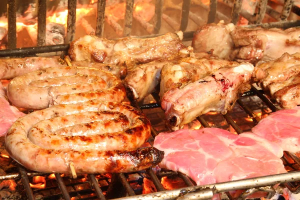 Fireplace home with the pork to be grilled over glowing embers — Stock Photo, Image