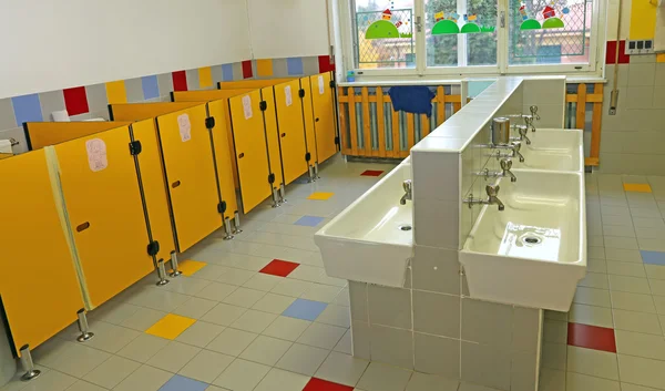 Large bathroom of a nursery with white sinks — Stock Photo, Image