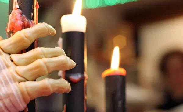 Skeleton of a hand that takes the candles — Stock Photo, Image