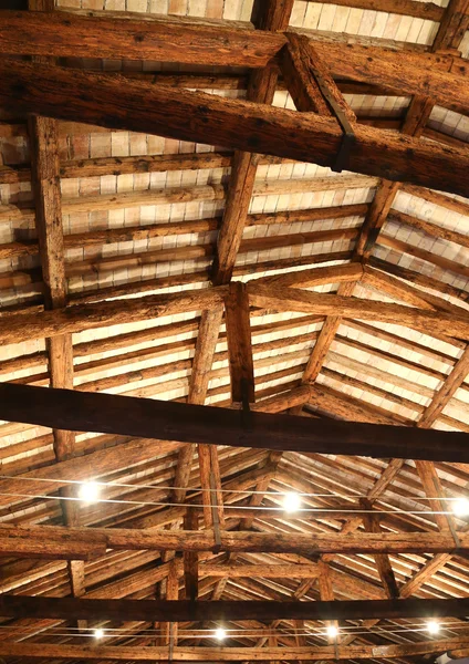 restored roof with wooden beams and the lamps