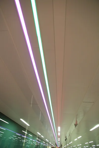 Neon tube lights in train station — Stock Photo, Image