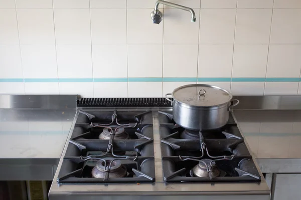 Pot over the stove of industrial kitchen in stainless steel — Stock Photo, Image