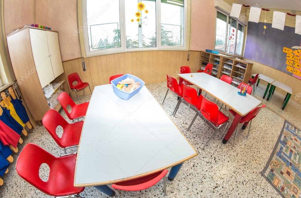 classroom nursery with red chairs and desks for children