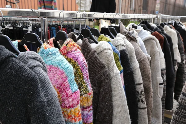 Sweaters and vintage clothes for sale at the  flea market — Stock Photo, Image