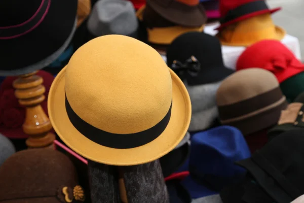 Yellow felt hat for sale in clothes store — Stock Photo, Image