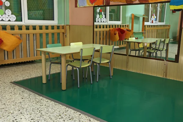 Tisch und Stühle im großen Kinderzimmer mit Spiegel — Stockfoto