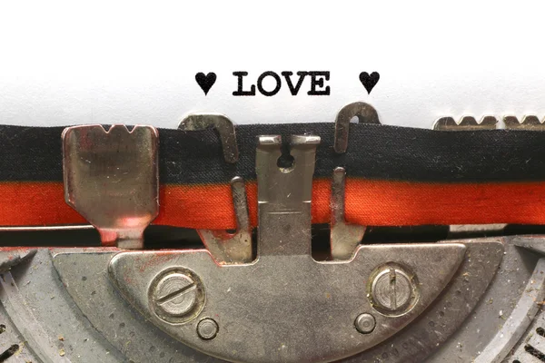 Written typewriter LOVE with black ink — Stock Photo, Image